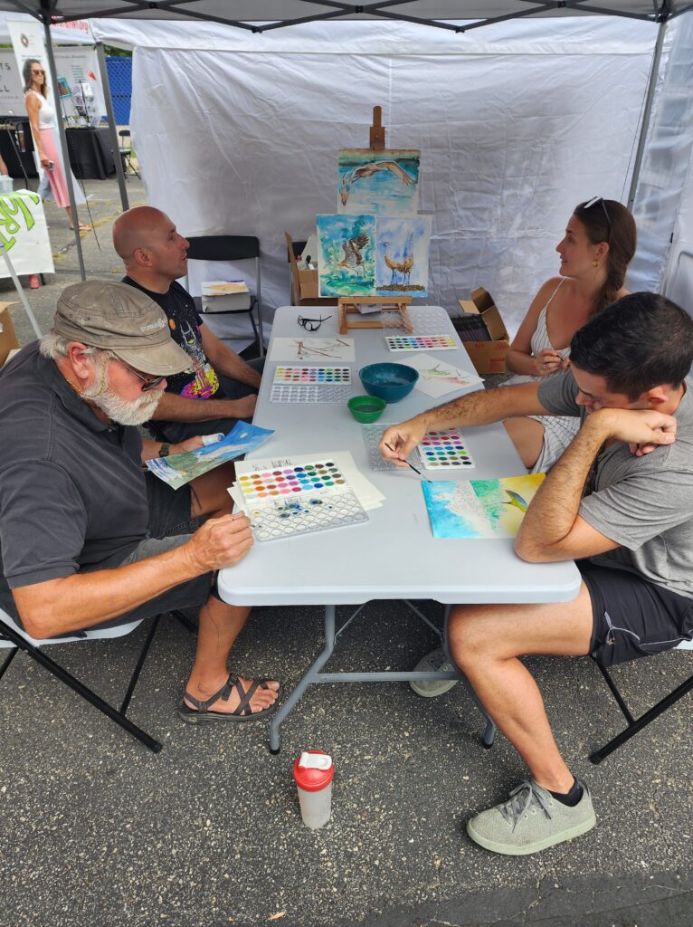 People participating in watercoloring activity at Dane Arts Buy Local event in 2022